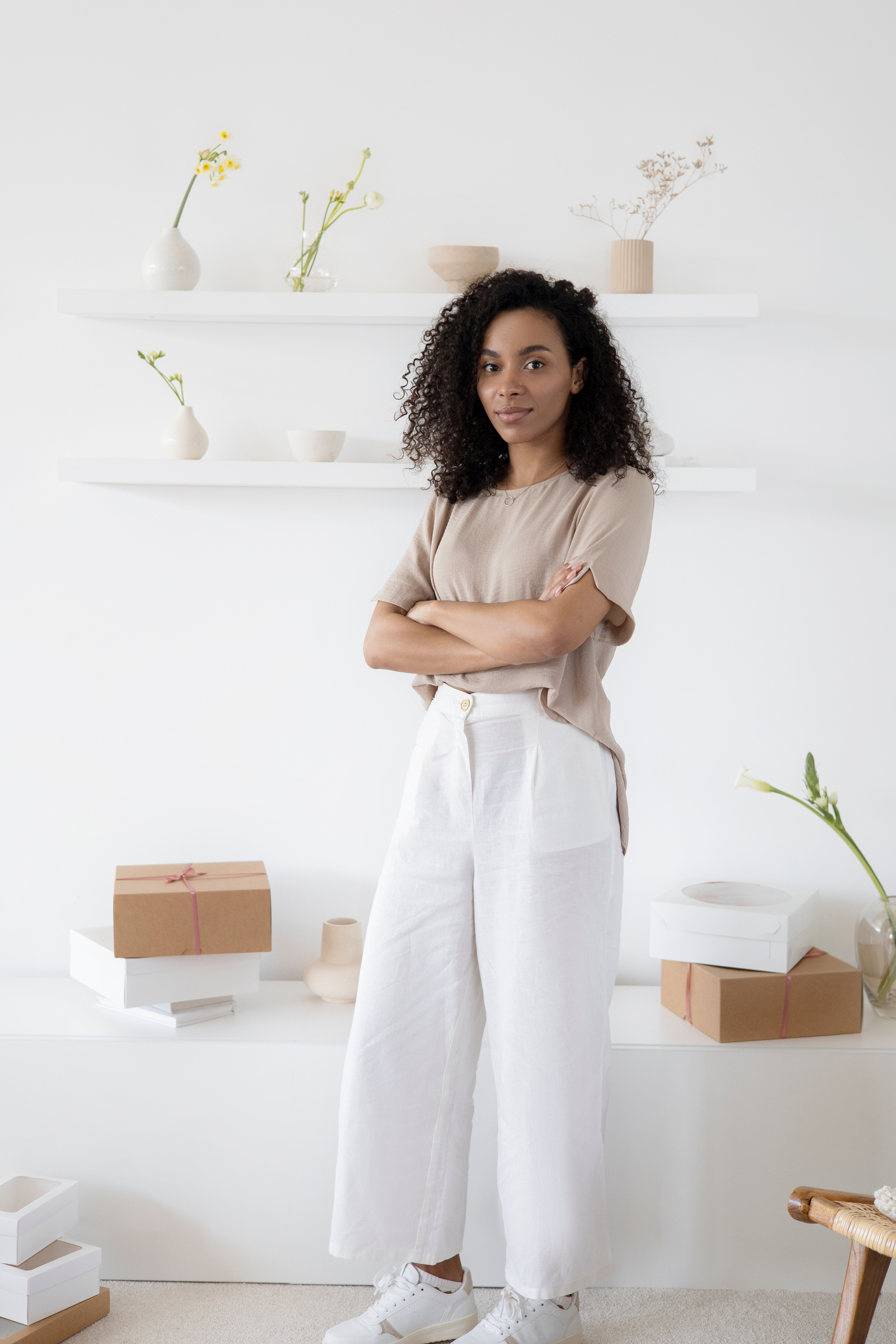 Woman in White Pants Near White Wall 